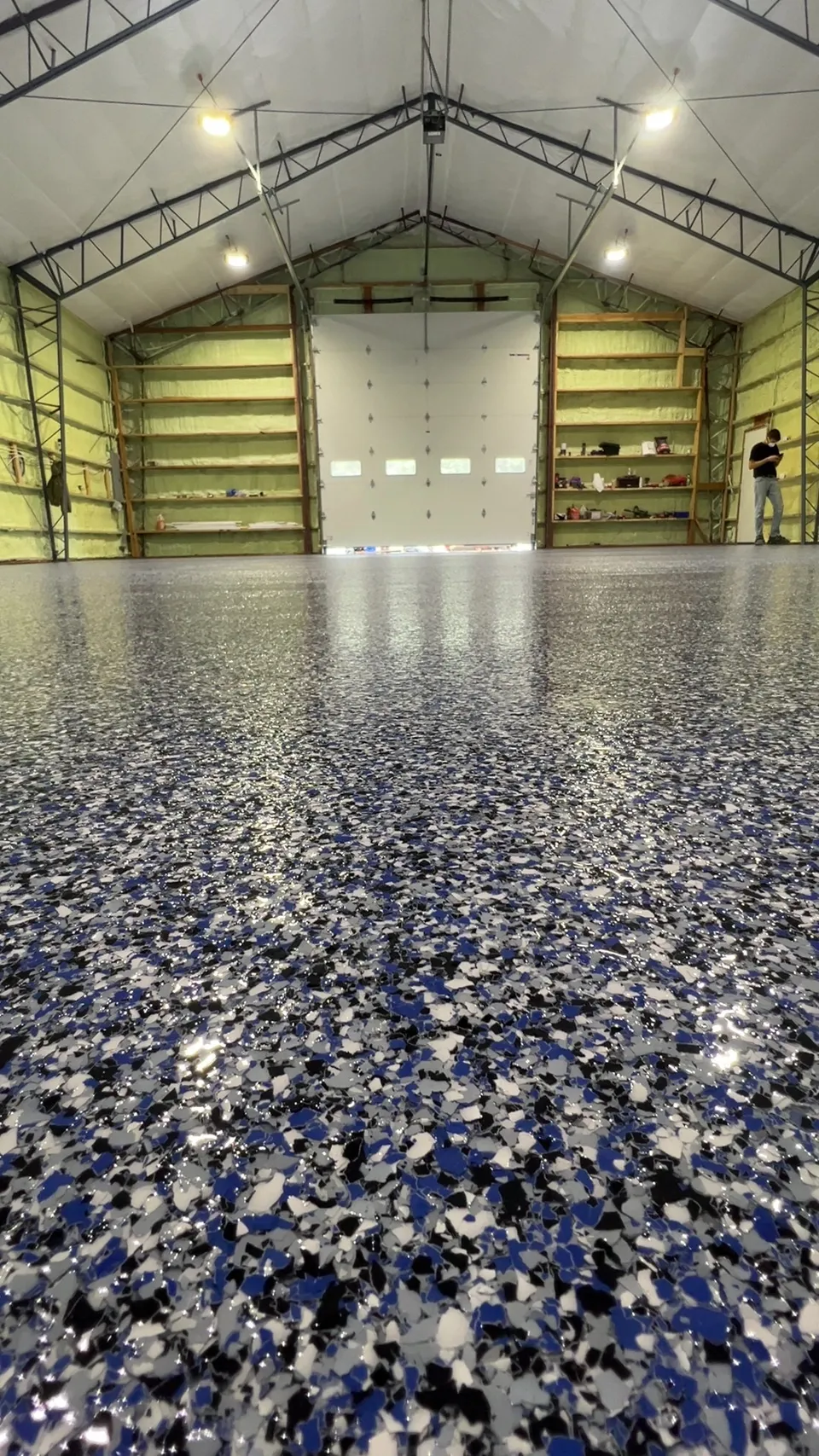 Glossy blue, white, and black flake floor in a large workshop